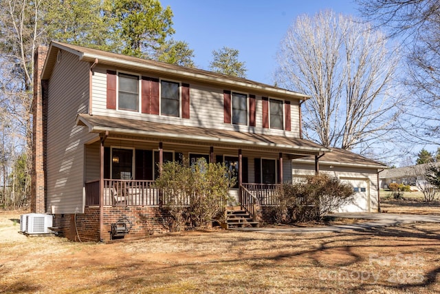 view of front facade with central air condition unit, driveway, covered porch, a garage, and a chimney