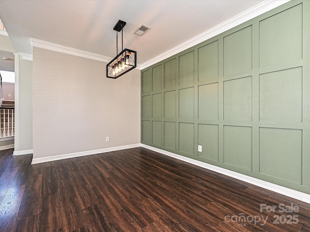 spare room featuring ornamental molding and dark hardwood / wood-style floors