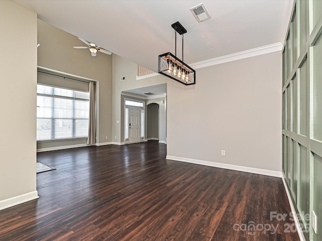 interior space with ceiling fan, crown molding, and dark wood-type flooring