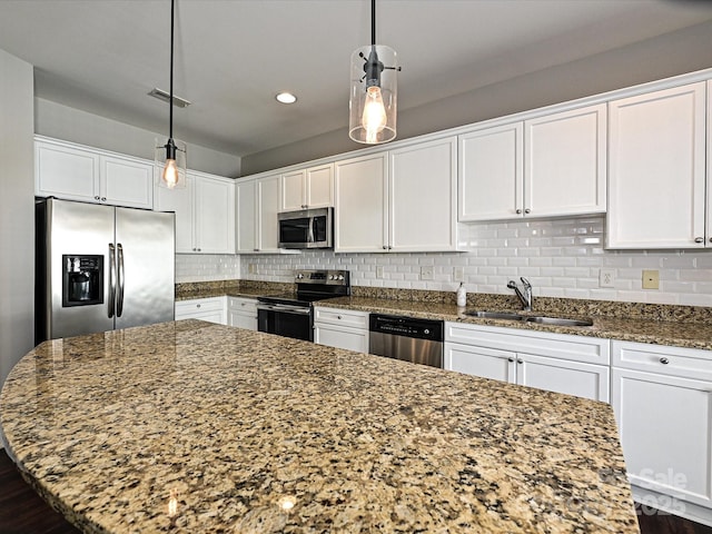 kitchen with stainless steel appliances, white cabinetry, and sink