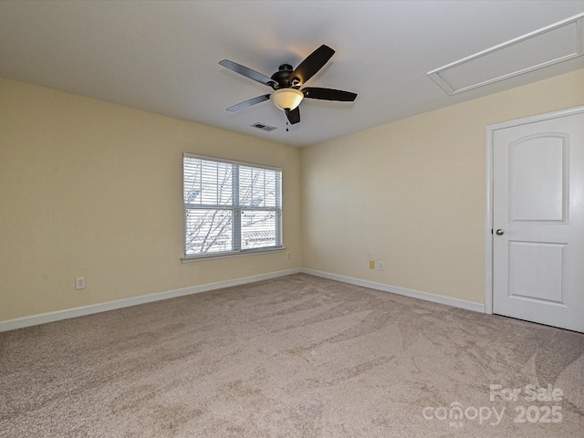 unfurnished room with light colored carpet and ceiling fan