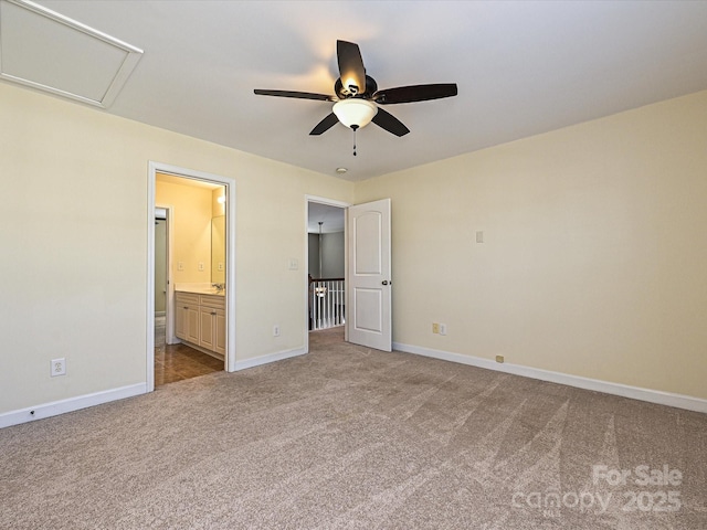 unfurnished bedroom with ceiling fan, light colored carpet, and connected bathroom