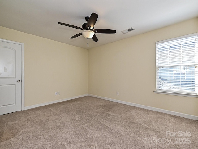 carpeted spare room with ceiling fan