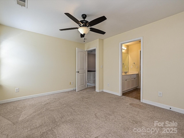 unfurnished bedroom featuring ensuite bathroom, light carpet, and ceiling fan