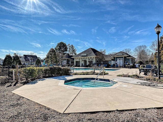 view of pool featuring a community hot tub and a patio