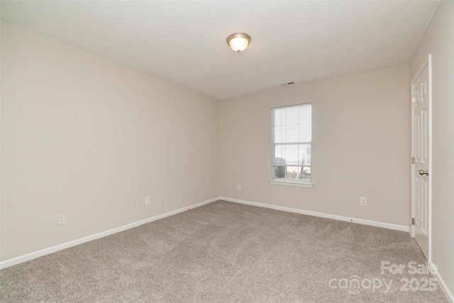 carpeted spare room with a textured ceiling