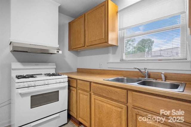 kitchen featuring sink and white gas range oven