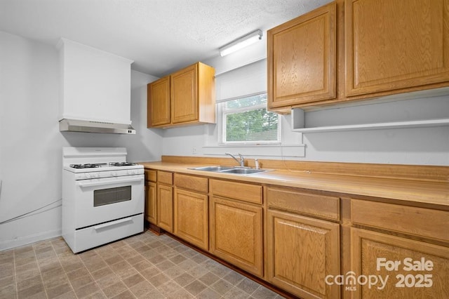 kitchen with butcher block countertops, sink, a textured ceiling, and white range with gas cooktop