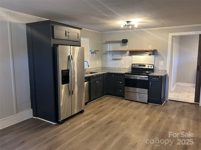 kitchen featuring wood-type flooring, sink, crown molding, light stone countertops, and appliances with stainless steel finishes