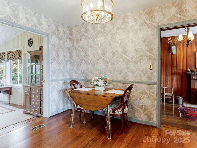 dining room featuring an inviting chandelier and dark hardwood / wood-style floors