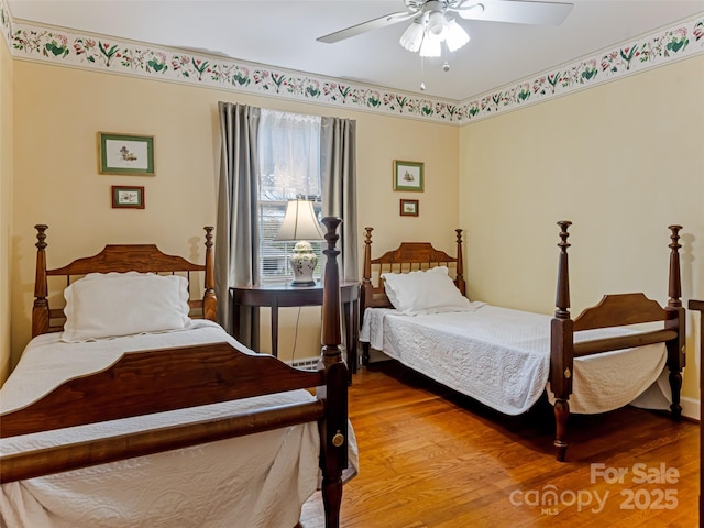 bedroom featuring ceiling fan and hardwood / wood-style floors