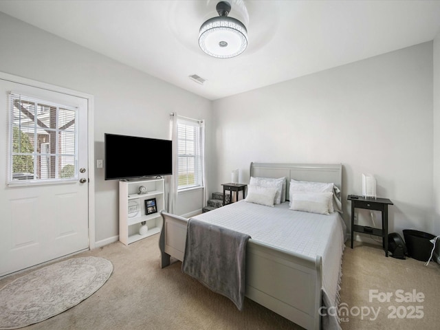 bedroom featuring light carpet