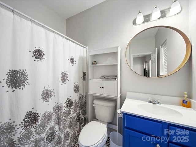 bathroom featuring toilet and vanity