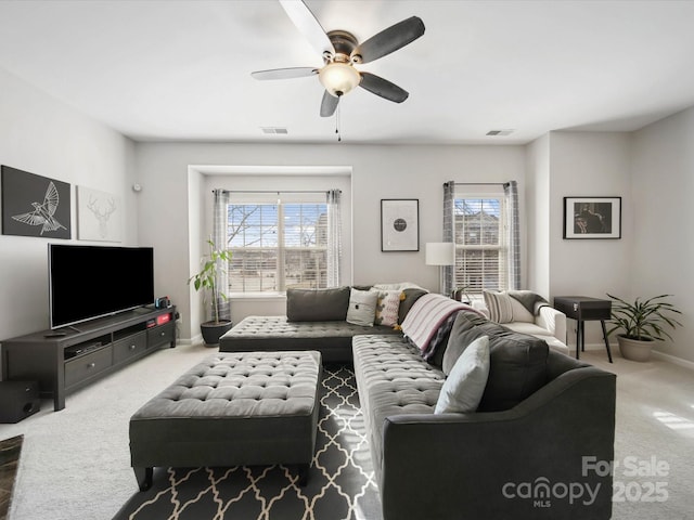 carpeted living room featuring ceiling fan