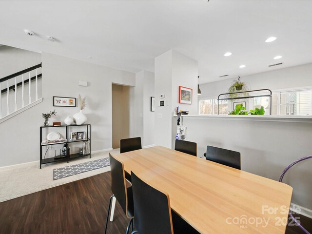 dining space with plenty of natural light and dark hardwood / wood-style floors