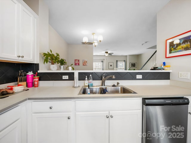 kitchen with ceiling fan with notable chandelier, white cabinetry, sink, kitchen peninsula, and stainless steel dishwasher