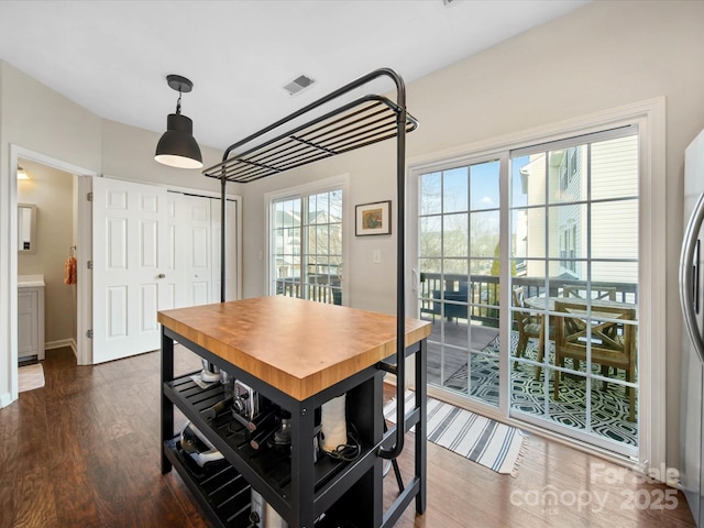 dining area featuring plenty of natural light and dark hardwood / wood-style flooring