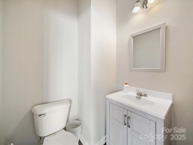 bathroom with toilet and vanity