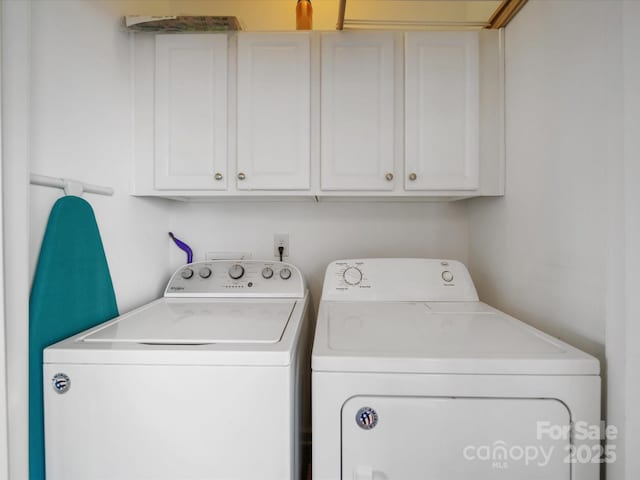 laundry room featuring cabinets and washing machine and dryer