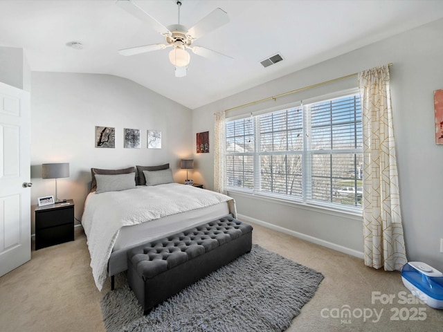 bedroom with ceiling fan, lofted ceiling, and light colored carpet