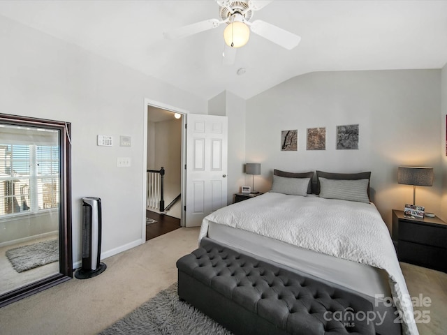 bedroom with ceiling fan, vaulted ceiling, and carpet flooring