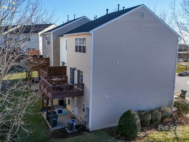 rear view of house featuring a patio area, central AC, and a deck