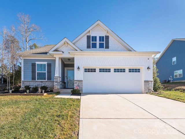 craftsman house with a garage and a front yard