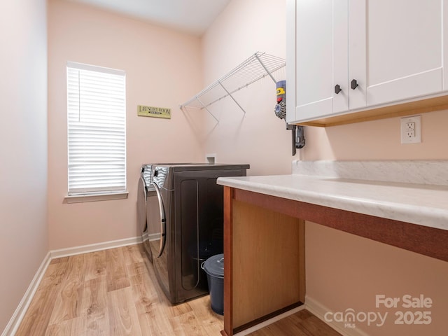 laundry room featuring cabinets, a wealth of natural light, light hardwood / wood-style flooring, and hookup for a washing machine