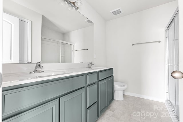 bathroom with walk in shower, vanity, and toilet