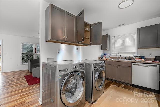 washroom with sink, light hardwood / wood-style flooring, and washer and dryer