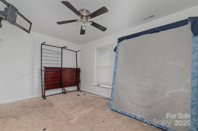 interior space featuring carpet floors and ceiling fan