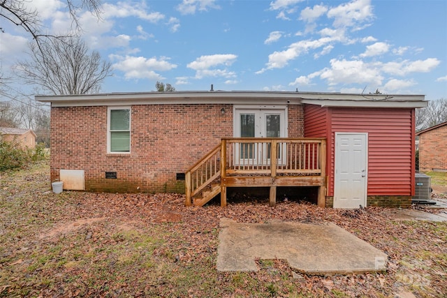 rear view of property with cooling unit, a patio area, french doors, and a deck