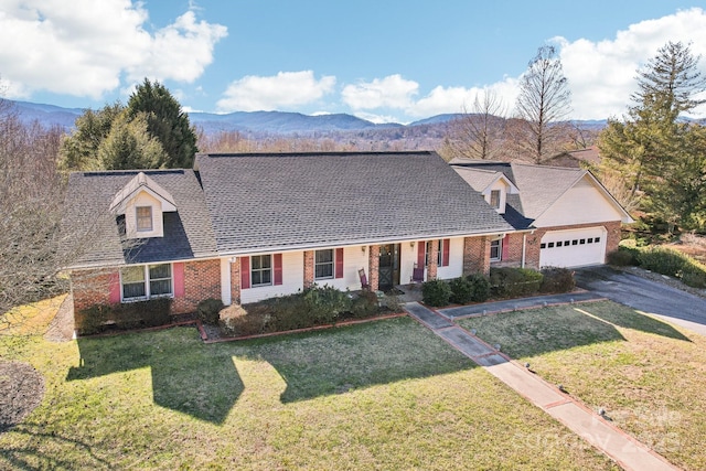 new england style home with a front yard, a garage, and a mountain view