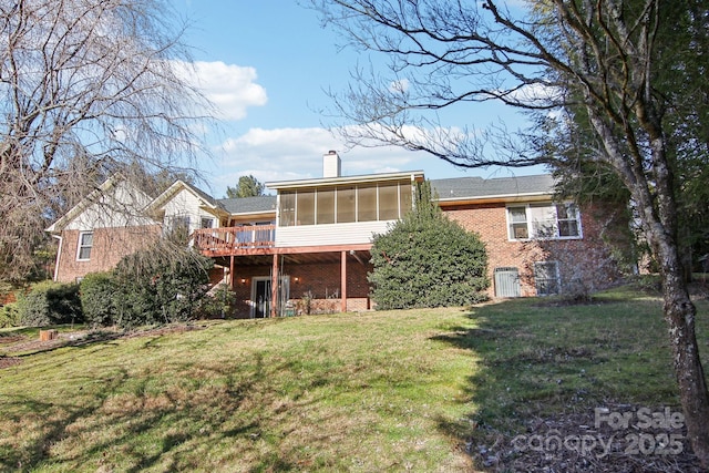 back of property with a sunroom and a lawn