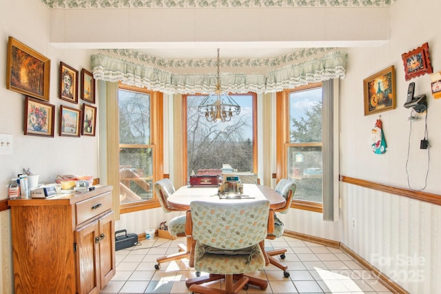 tiled dining area with a chandelier