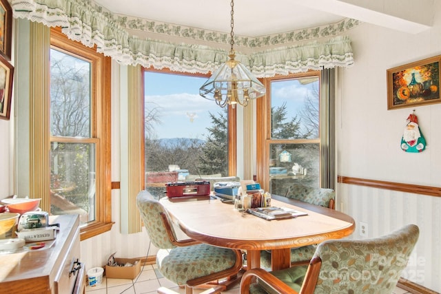 dining space featuring light tile patterned floors and a notable chandelier