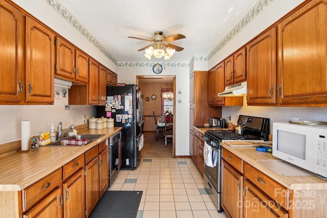 kitchen featuring ceiling fan, light tile patterned floors, sink, and black appliances