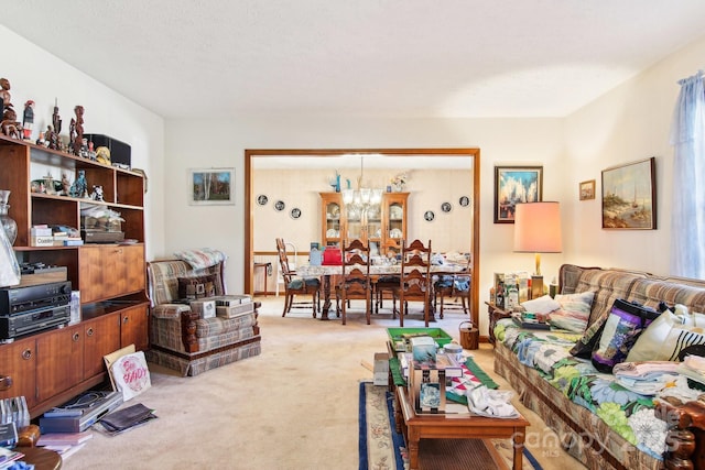 living room with an inviting chandelier and light colored carpet