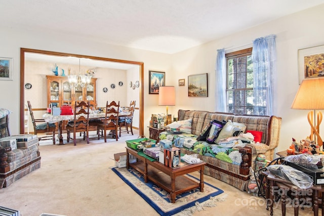 living room featuring a notable chandelier and carpet flooring