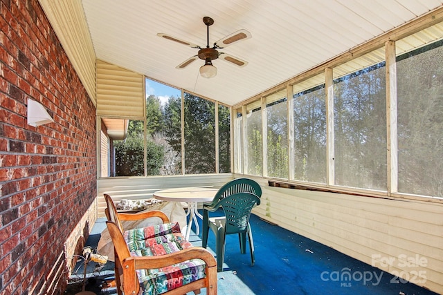 unfurnished sunroom with ceiling fan and lofted ceiling