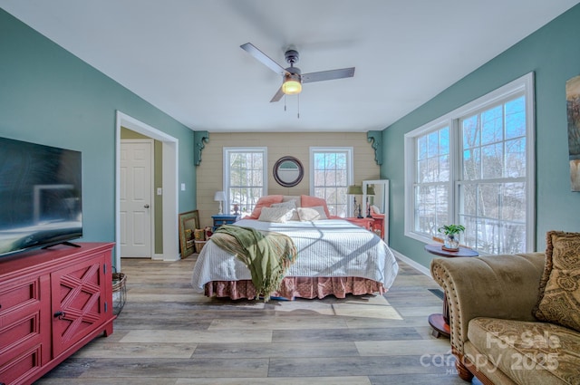 bedroom with ceiling fan and light hardwood / wood-style floors