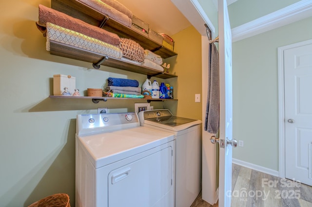 laundry room with light hardwood / wood-style floors and independent washer and dryer