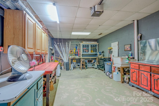 basement with a workshop area and a drop ceiling