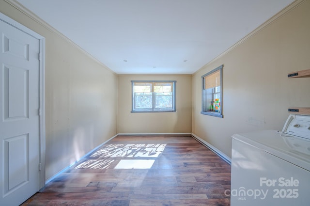 clothes washing area with washer and dryer, crown molding, and dark hardwood / wood-style floors