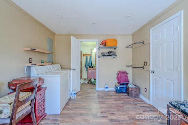 washroom featuring light wood-type flooring, crown molding, and independent washer and dryer