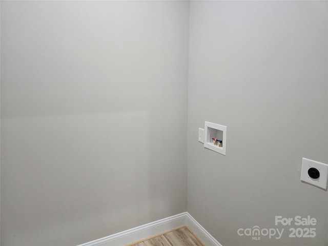 washroom with hardwood / wood-style flooring, hookup for a washing machine, and electric dryer hookup