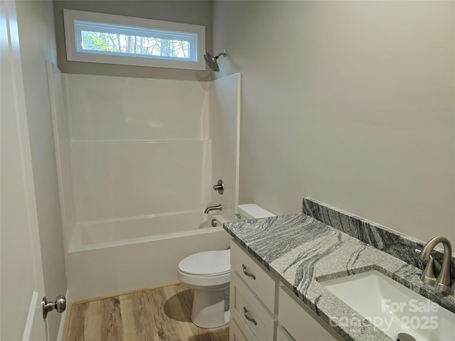 full bathroom with shower / bathtub combination, wood-type flooring, toilet, and vanity