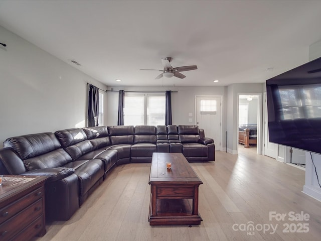 living room with ceiling fan and light wood-type flooring