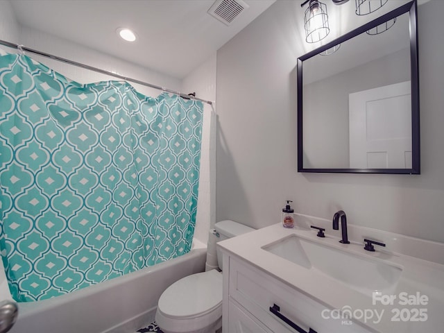 full bathroom featuring vanity, shower / bath combo with shower curtain, and toilet