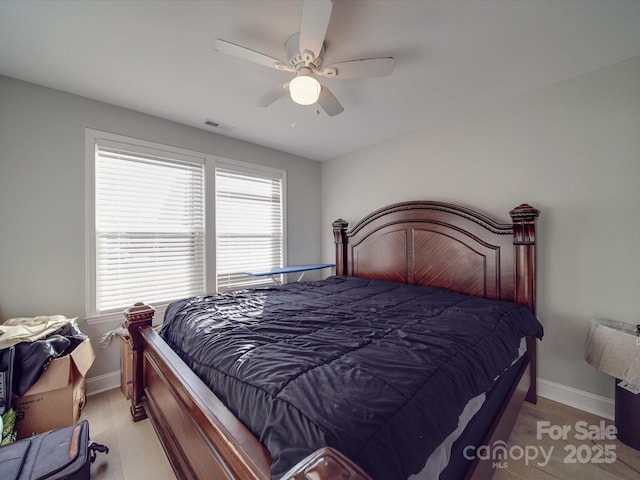 bedroom featuring multiple windows and ceiling fan